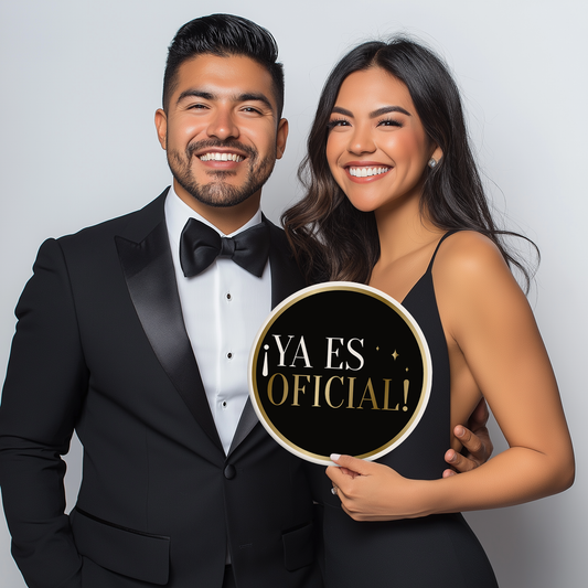 A couple posing with an engagement ring prop