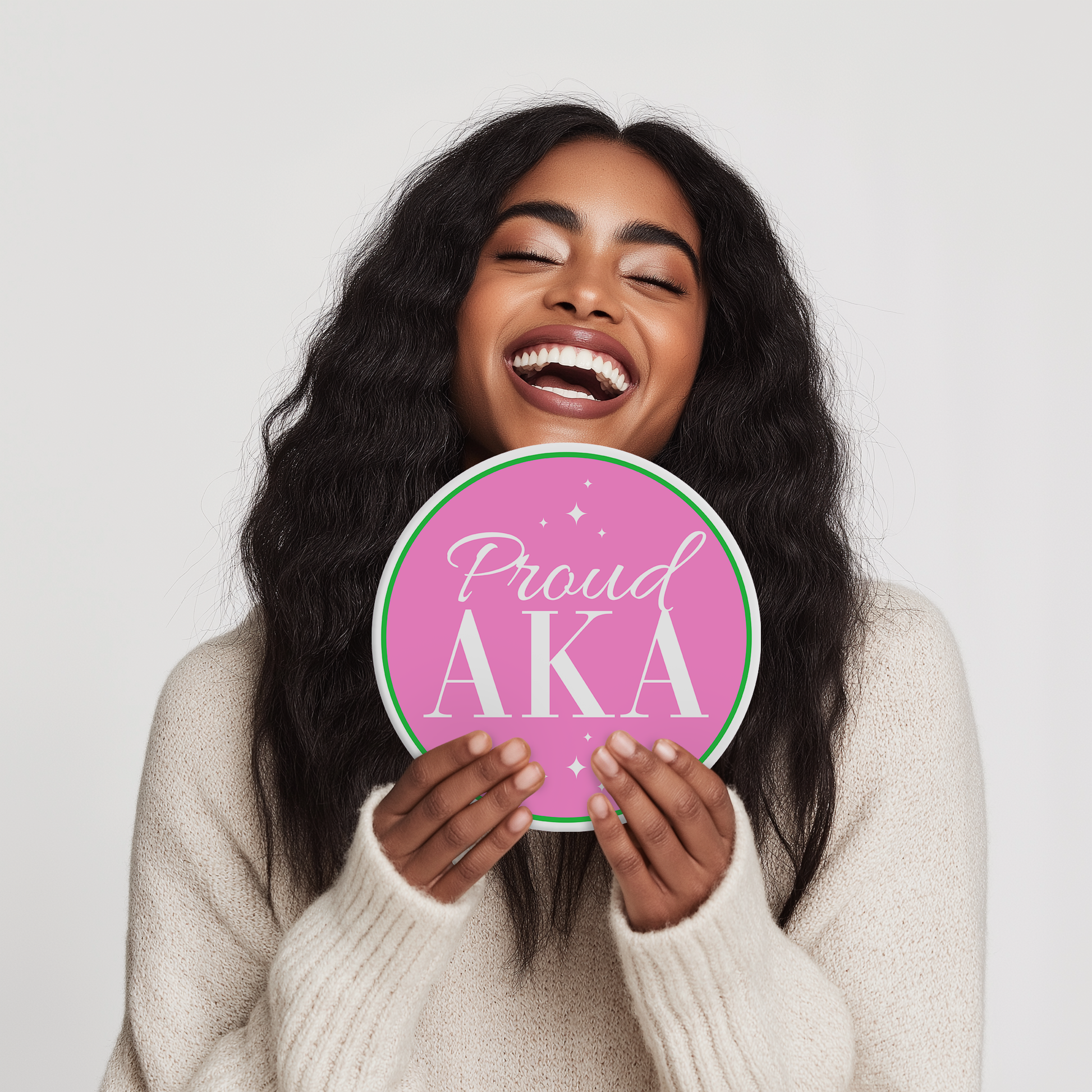 Woman holding AKA sorority-themed photo booth props featuring elegant and iconic designs